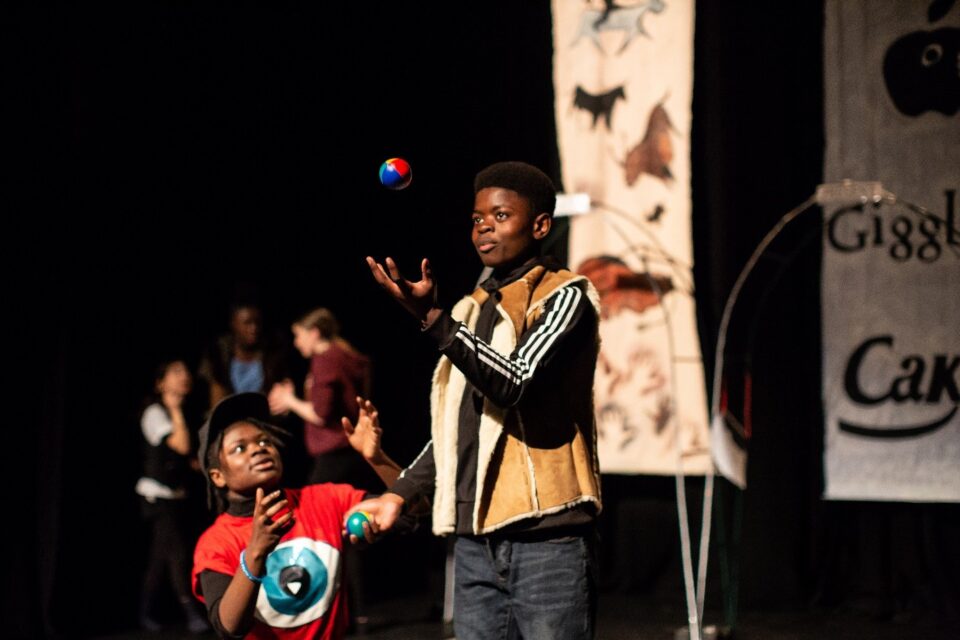 A young performer juggling