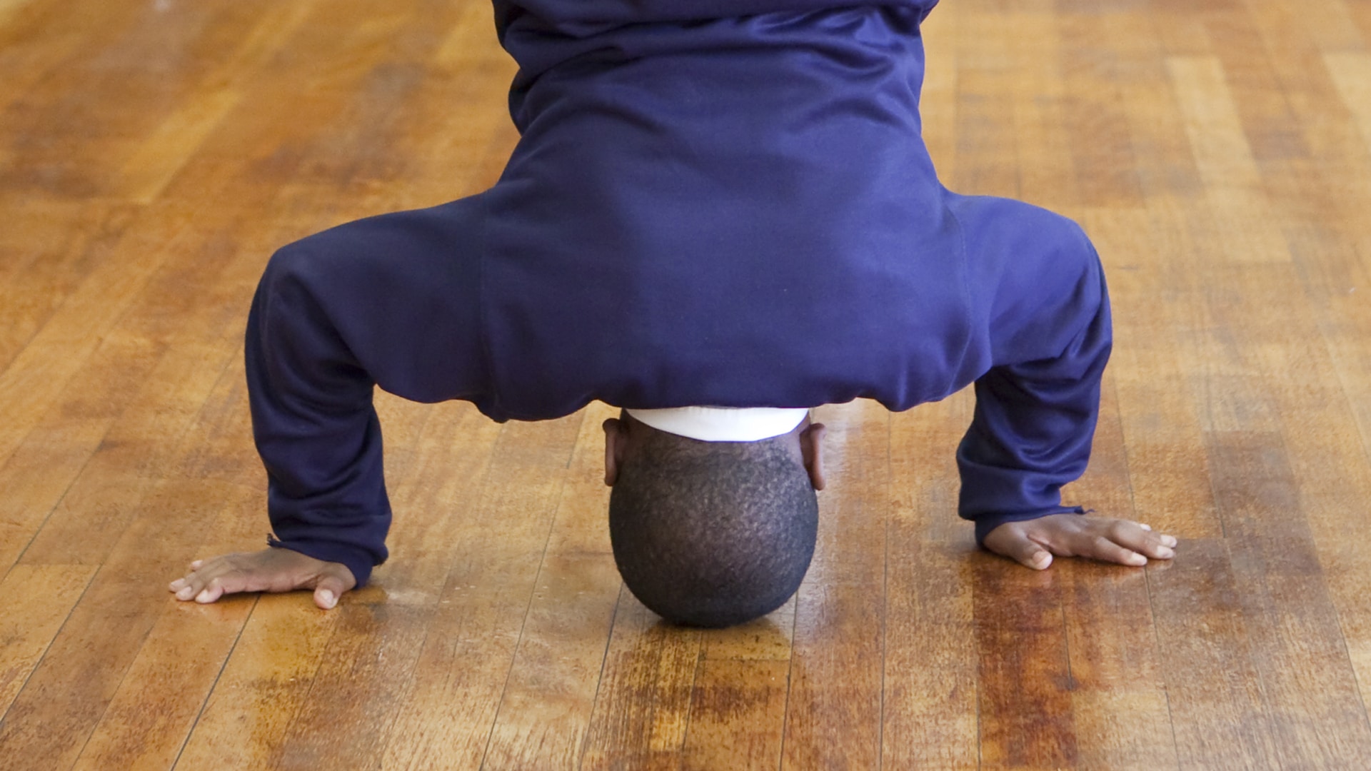 A schoolchild balancing on their head
