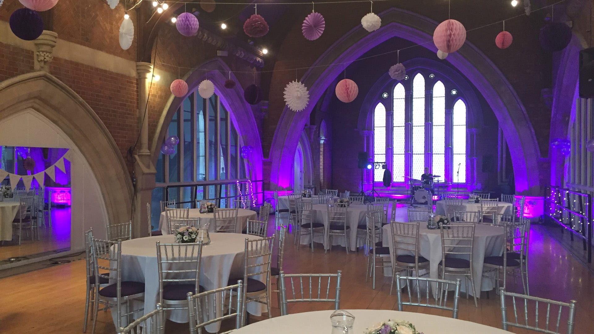 Studio 1 at Jacksons Lane prepared for a wedding - there's a stage for the band, bunting, and tables