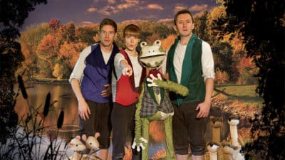 The human sized puppet of Mr Toad stands amongst his three human fellow cast members. At their feet at puppets of mice and weasels