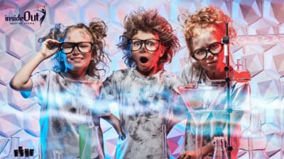 3 children dressed as scientists with black rimmed glasses and ash smothered over their faces