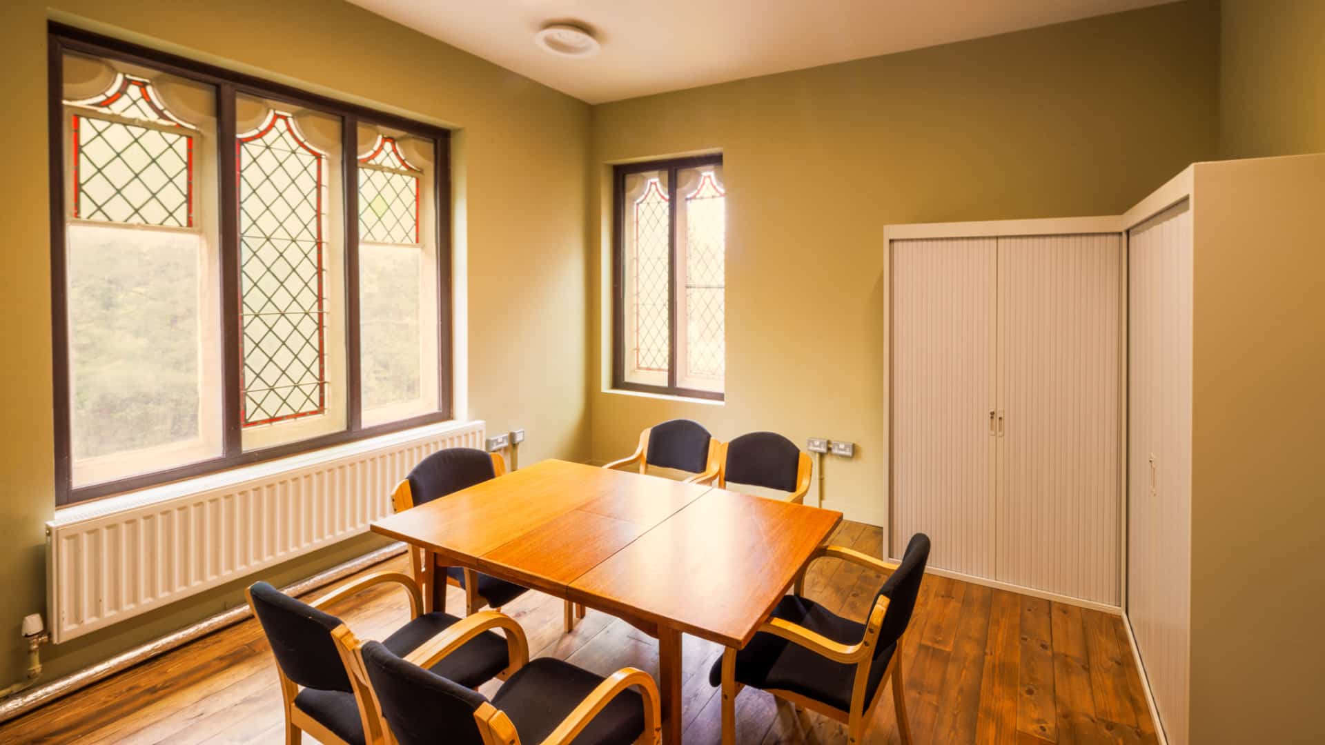 A small sunlight room with a table and six chairs